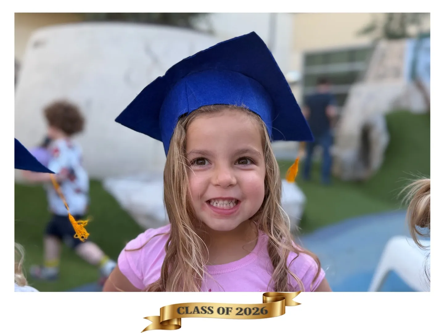 A graduate at a Bay Area commencement holding their custom Magneteam magnet keepsake.